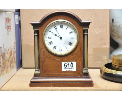 A small inlaid mantle clock with enamel dial