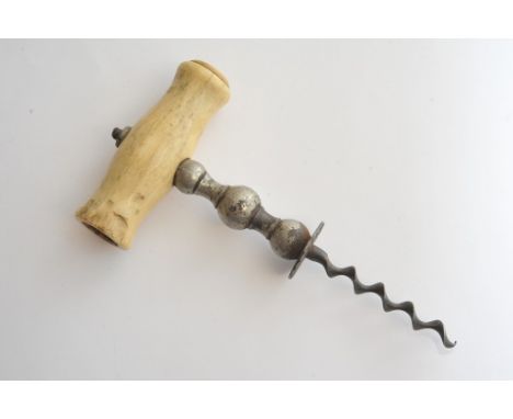 A vintage cork screw with a bone handle
