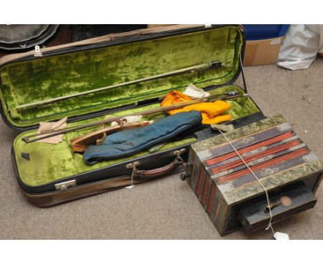An old accordion and and empty violin case containing some bows