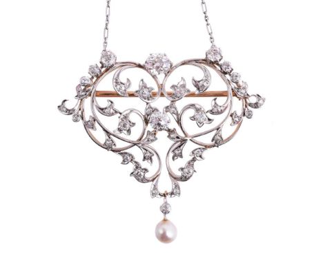 AN ART NOUVEAU DIAMOND AND PEARL BROOCH/PENDANT CIRCA 1910The pierced scrolled foliate pendant set with graduated old brillia