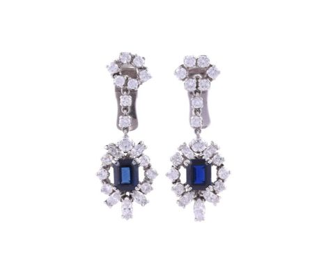 A PAIR OF SAPPHIRE AND DIAMOND CLUSTER EAR PENDANTSThe open cluster drops centred with a step cut sapphire with canted corner