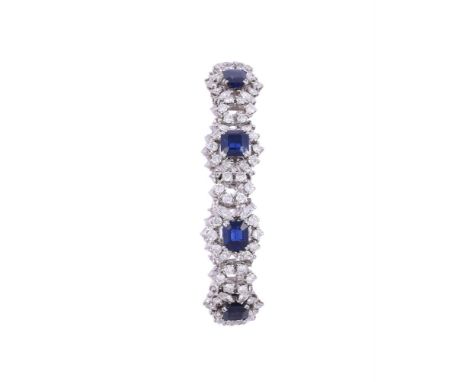 A SAPPHIRE AND DIAMOND CLUSTER BRACELETThe open clusters centred with a step cut sapphire with canted corners within a surrou