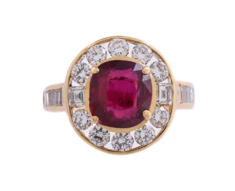 A RUBY AND DIAMOND CLUSTER RINGThe cushion cut ruby estimated to weigh 1.86 carats, within a surround of brilliant cut and st