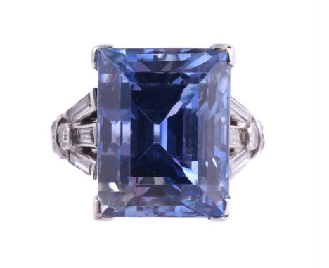 AN ART DECO SAPPHIRE AND DIAMOND DRESS RING CIRCA 1930The step cut sapphire estimated to weigh 13.37 carats in a four claw se