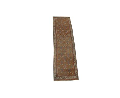 A Caucasian runner, with repeated flower decoration within diamond-shaped cells, 396 x 98cms.