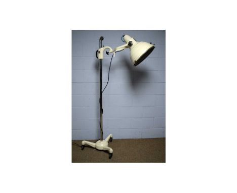 A mid-Century Hanovia Sollux Model 10 floor standing heat lamp, cream finish, adjustable shade and on a base with castors, he
