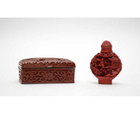 A Chinese cinnabar lacquered snuff box and cover, decorated with figures and temples within foliage, 7cms high; together with