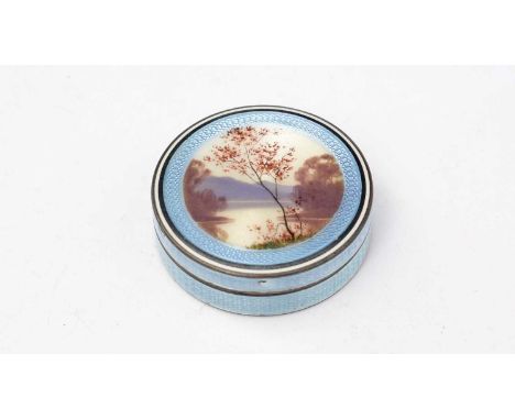 A Dutch silver and enamel pill pot, decorated in engine turned and painted enamel with a landscape, gilt interior. 
