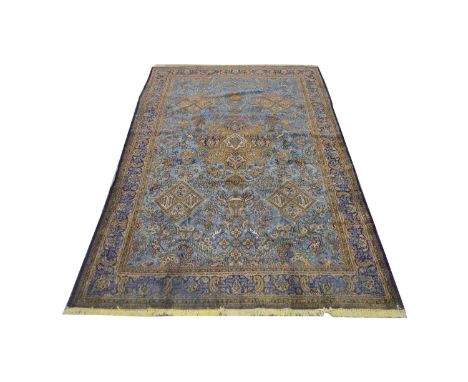 A Ghom carpet, the central medallion surrounded by diamond-shaped medallions and foliate scrolls and beasts, 360 x 234cms.