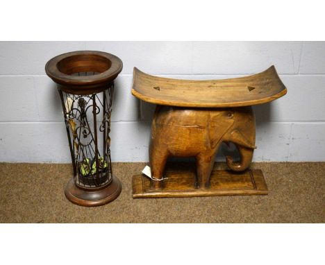 A carved Asian hardwood stool with elephant base, 57 x 50cms high; and a wrought metal and stained wood stick stand, 29 x 59c