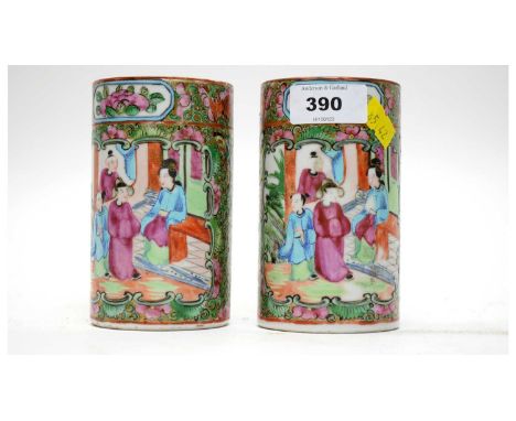 A pair of Chinese Famille Rose sleeve vases, decorated with panels of figures and flowering foliage, 11cms high.