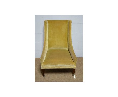 A 19th Century easy armchair, upholstered in a studded gold plush, on stained wood square tapered, legs with ceramic castors,