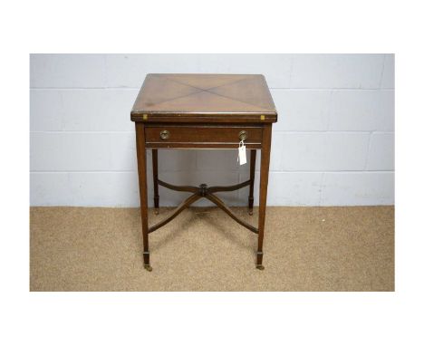 An early 20th Century mahogany envelope card table, the swivel top opening to reveal a baize-lined playing surface with count