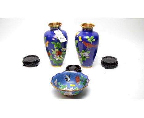 A pair of Chinese cloisonné enamel vases, decorated with tropical birds on colourful flowering foliage, 22cms high; and a clo