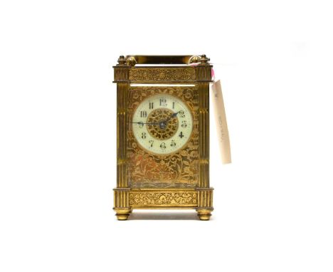 A 19th Century brass carriage clock, the cream enamel Arabic dial with numerals in black, 15.5cms high (including handle).