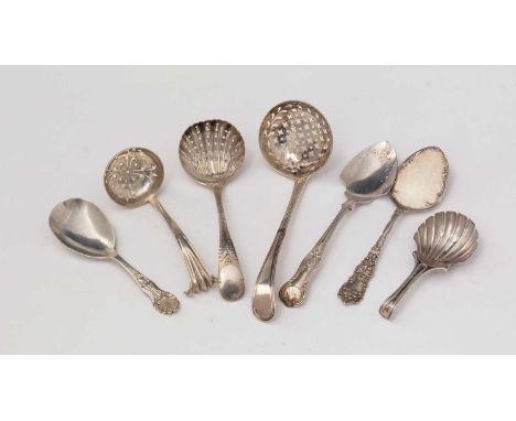 Three silver sugar sifting spoons; two silver caddy spoons, one by Saunders &amp; Shephard; and two silver tartlet slices, 5.