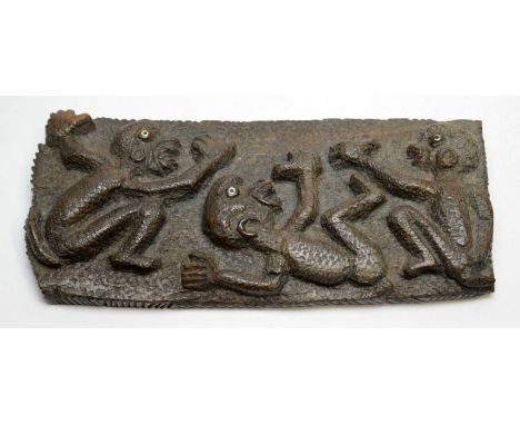 Unusual tribal wall plaque, carved with three figures inset with black and white eyes, 30 x 14cms high.