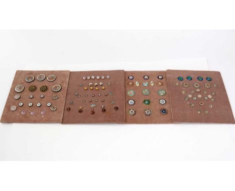 A collection of enamel buttons, including a set of four of Arts and Crafts design; four with dog pattern intaglios; and other