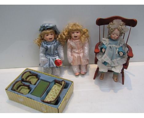 Two boxed German modern dolls, doll on chair and ceramic dolls house furniture 