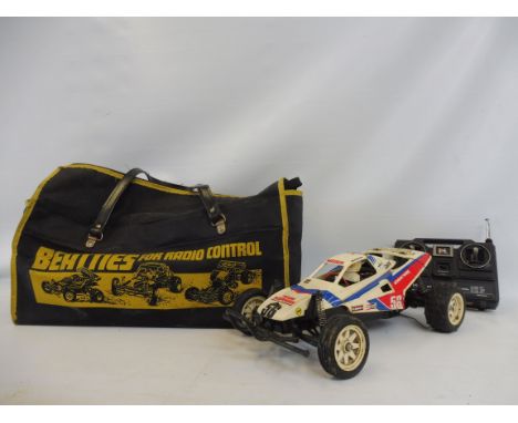 A Tamiya Grass Hopper II buggy circa 1988-1995, original high impact styrene body complete with a Futaba controller.