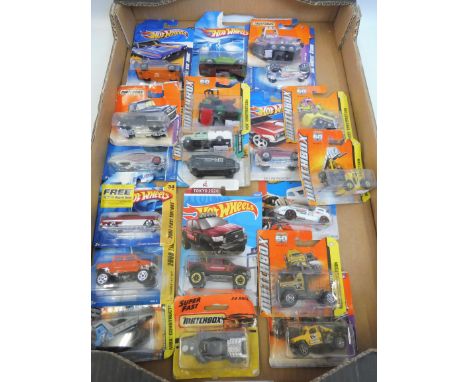 A selection of Hot Wheels and Matchbox carded model cars.