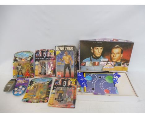 A collection of original Star Trek figures on card, an original AMT Captain Kirk model, still sealed, phasers etc.