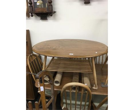 Blonde Ercol Oval Coffee Table, Good Condition, Approx measurements 39 Inches by 33 inches, Magazine shelf underneath.