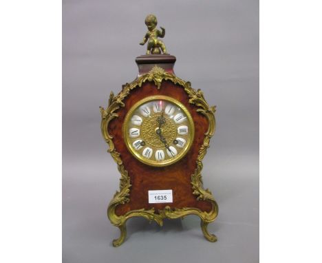 Reproduction figured walnut mantel clock in antique French style with a gilt dial, enamel cartouche numerals and two train mo