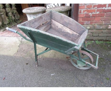 Green painted wooden garden wheelbarrow, together with a garden roller 