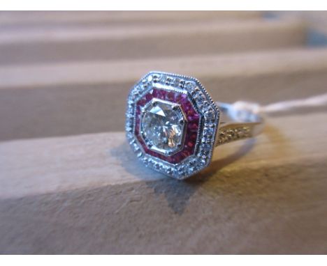 18ct White gold diamond and ruby set target ring, the centre diamond approximately 0.65ct 