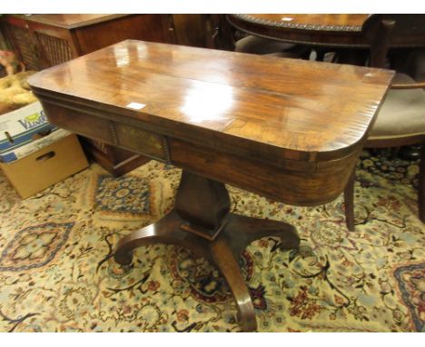 Regency rosewood fold-over card table with a square baluster column support and quadruped base 