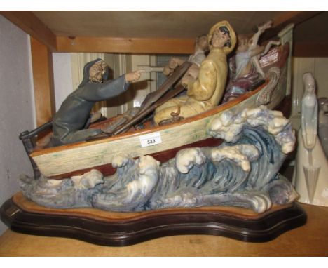 Large Lladro group of figures, boy with dog in a boat in rough seas (at fault), on a moulded wooden plinth base, 18ins high x