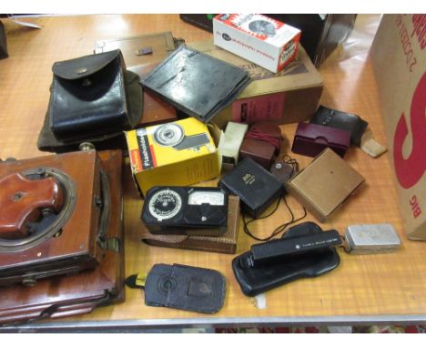 Leica cased light meter, together with a quantity of camera accessories and various camera plates 