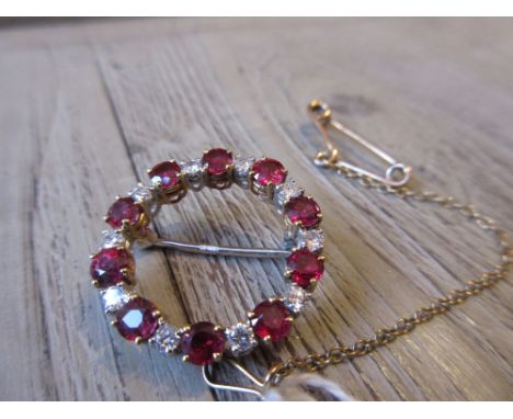 Yellow and white gold circular diamond and ruby set brooch with guard chainUnmarked, carat not known.23mm in diameter. 5g in 