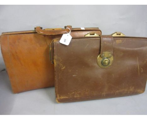 Vintage leather attache case with a combination lock together with another 