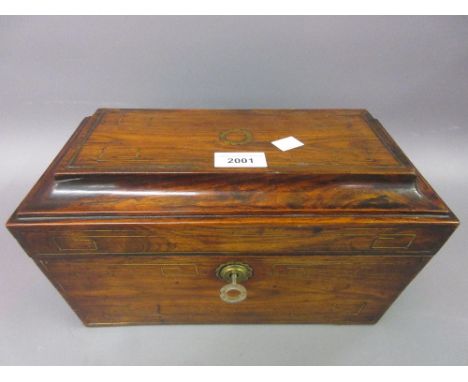 Regency rosewood and brass line inlaid sarcophagus shaped tea caddy with a three division interior 