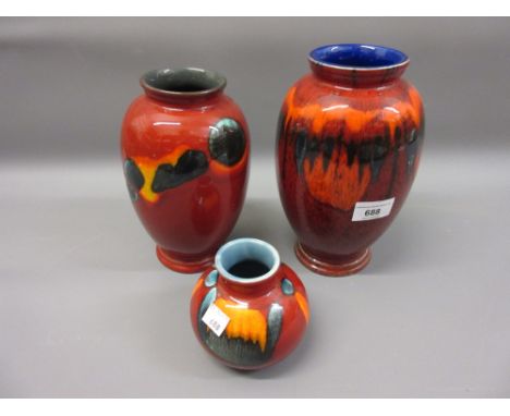 Modern Poole Pottery red slip glazed baluster form vase, together with two similar smaller vases 