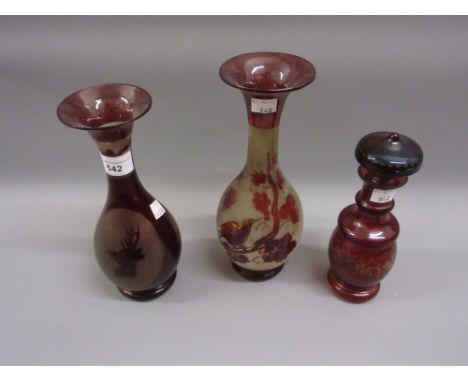 Two ruby flash glass baluster form vases together with a similar small decanter 