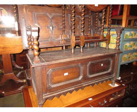 Late 19th or early 20th Century oak monks bench, the flip-over top on barley twist supports above box base 