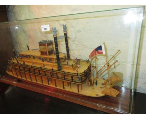 Wooden scale model of the paddle steamer ' River Queen ', housed in a glazed cabinet 