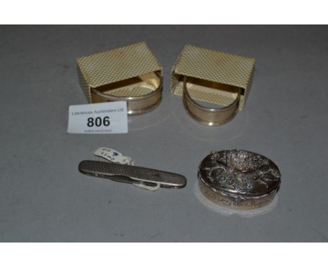 Two silver napkin rings, silver cased penknife and a small plated trinket box 