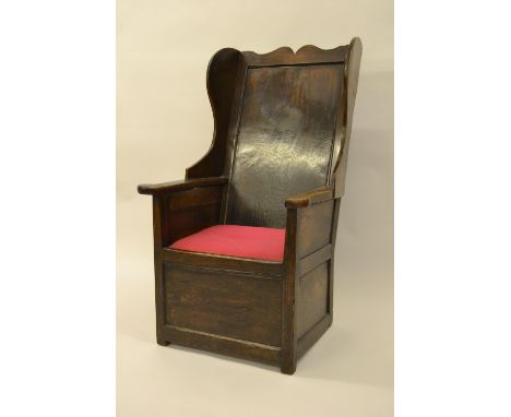18th Century oak lambing chair, the panelled wing back above a typical box seatDoes have some old repairs to arm rest and is 