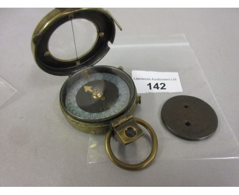 Military issue brass compass, together with an English cartwheel ha'penny (at fault) 