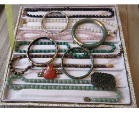 Two Chinese brooches, four various bangles and a group of six bead necklaces with silver gilt clasps 