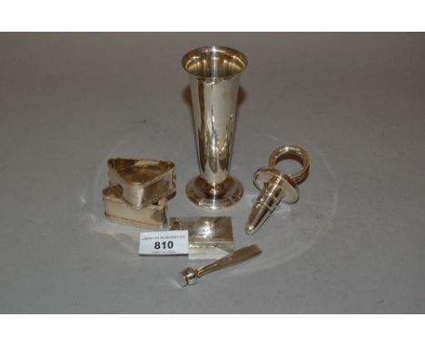 Small silver specimen vase, silver bottle stopper, trinket box, two napkin rings and a Tiffany and Co. seal 