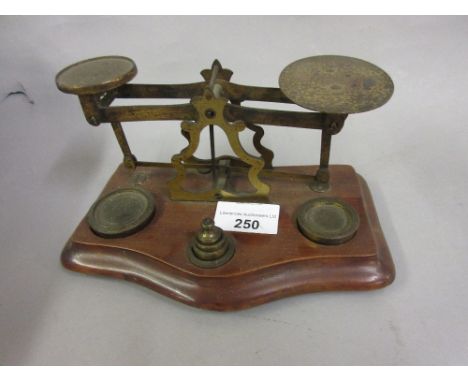 Pair of small mahogany and brass postal scales with graduated set of weights 
