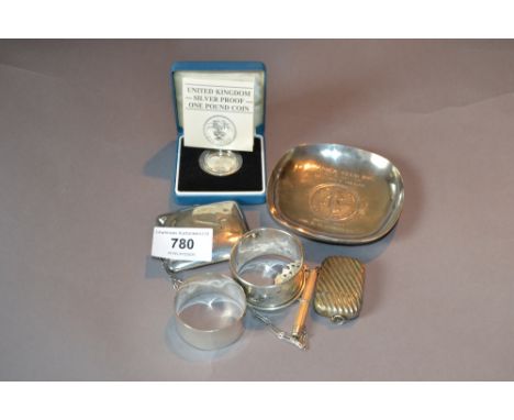 Sterling silver triple section coin case with attached chain, silver proof one pound coin, two silver napkin rings, silver to