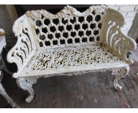 Small painted cast iron two seat garden bench with lattice work back 