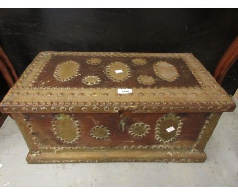 Small Zanzibar teak metal studded and brass mounted trunk with a hinged cover and fitted interior 