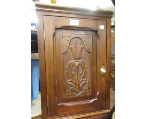 Small carved walnut hanging corner cabinet with single panelled door together with a stained beechwood commode elbow chair 